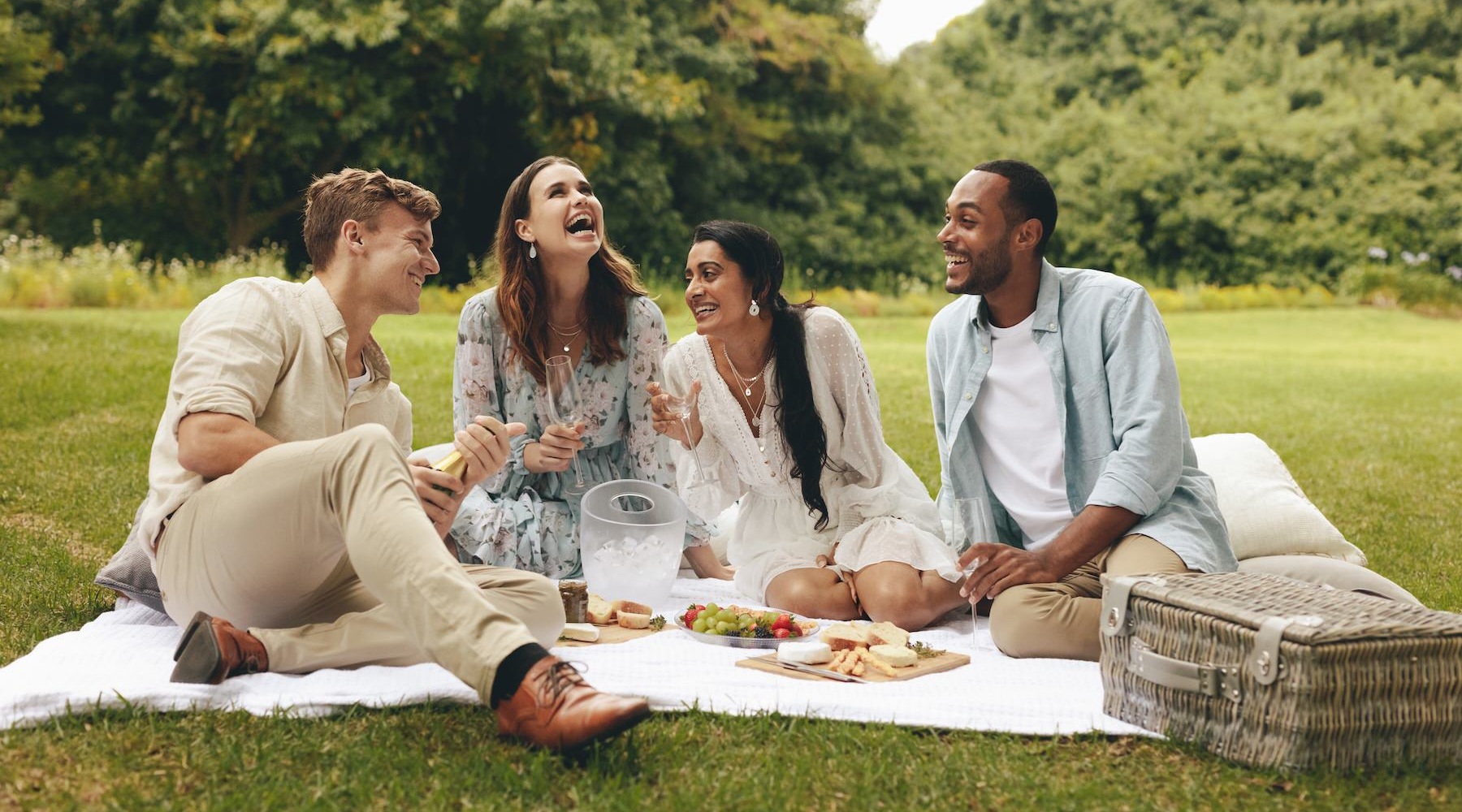 a group of friends having a picnic in a park