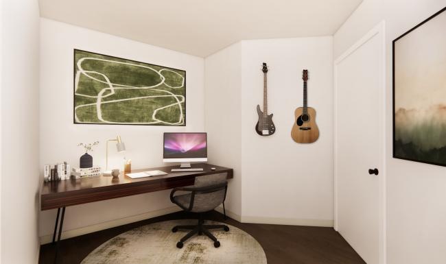 a home office with desk computer guitars and art on a wall